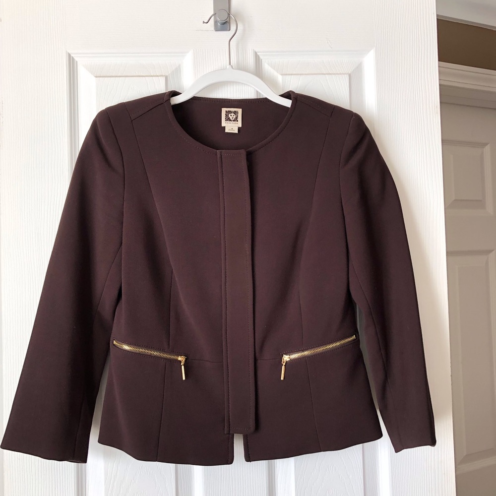 Brown blazer with gold zippered accents.